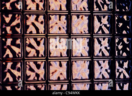Colorful light patterns on translucent architectural glass block wall Stock Photo