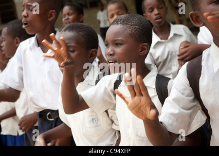 Students sing together in the courtyard of Mjimpya Primary School in Dar es Salaam, Tanzania. Stock Photo