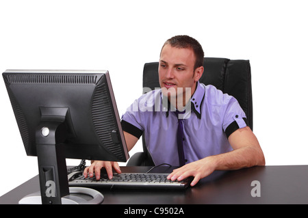 Young man working on his computer in an office. Stock Photo