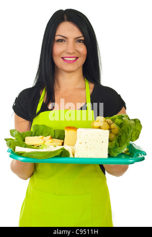 Portrait of attractive market worker female serving different cheese on plateau isolated on white background Stock Photo