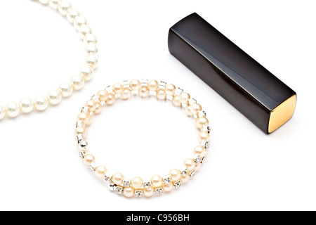 Pearl bracelet ,necklace and lipstick on white background Stock Photo