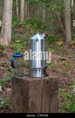 A wood-burning Kelly Kettle in use at a woodland picnic, UK Stock Photo