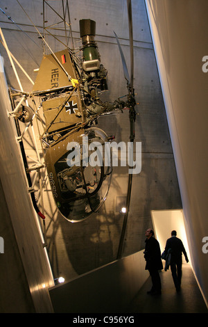 Visitors are watching an helicopter SE 3130 of the Bundeswehr displayed in the Military History Museum in Dresden, Germany.