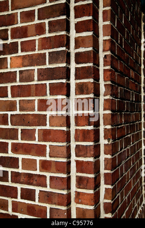 Red Brick Wall at the corner of an apartment building Stock Photo