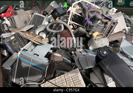 Discarded electrical equipment - computers, printers, vacuums, monitors etc - in a skip at a recycling centre in the UK Stock Photo