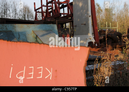 ironic Keep notice on scrapped metal, scrap metal yard of engineering firm Stock Photo
