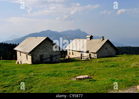 Typical Northern Italian Alps houses called Baita, made of wood and stone. In Trentino Stock Photo