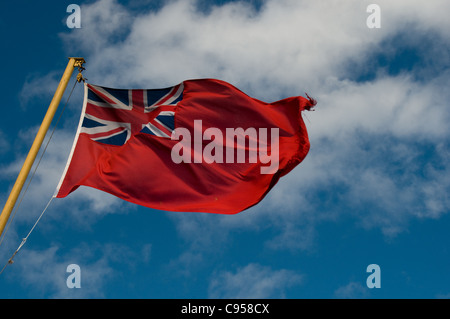 The red ensign flies proudly on the stern of the ship Clansman on a sunny day while on a voyage from Oban to Castlebay. Stock Photo