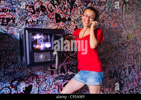 Teenaged girl poses for photos in graffiti covered alley leading to Casa de Giulietta in Verona Italy. Stock Photo