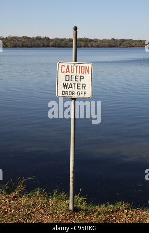 A sign cautioning of deep water next to a lake in Minneapolis. Stock Photo