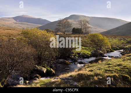 View to derelict farm building Moel Cynghorion and Crib-y-Ddysgl across Afon Arddu river near Llanberis Gwynedd North Wales UK Stock Photo