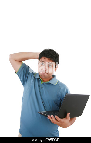 Worried young sman working on laptop Stock Photo