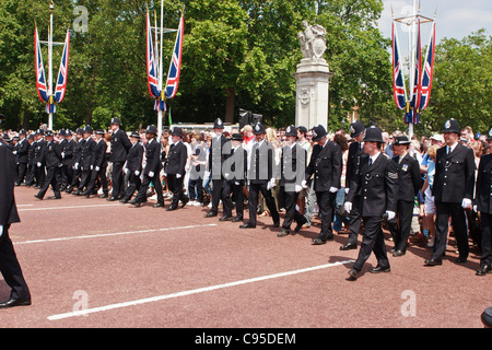 British police leading the crowd during Queen's Birthday Parade celebration on Pall Mall to Buckingham Palace, London. Stock Photo