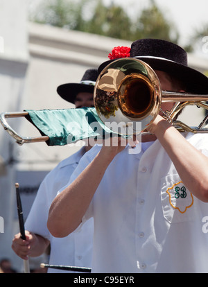 Musician playing trombone and marching in a parade Stock Photo