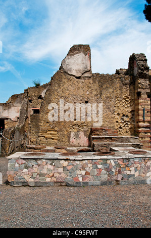 The Grande Taberna, an excavated tavern (thermopolium) situated opposite the sports complex on Cardo V inferiore, Herculaneum Stock Photo