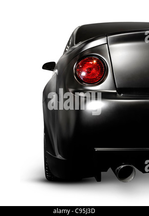 License and prints at MaximImages.com - Closeup of a mat black exotic custom car back with a tail light. Isolated on white background. Stock Photo