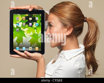 License available at MaximImages.com - Smiling young asian woman student with Apple iPad tablet in her hands Stock Photo