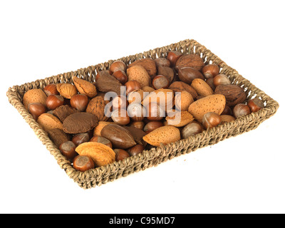Wicker Basket Or Tray Of Whole Mixed Healthy Nuts With Their Shells On Against A White Background With A Clipping Path And No People Stock Photo