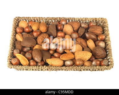 Wicker Basket Or Tray Of Whole Mixed Healthy Nuts With Their Shells On Against A White Background With A Clipping Path And No People Stock Photo