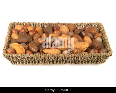 Wicker Basket Or Tray Of Whole Mixed Healthy Nuts With Their Shells On Against A White Background With A Clipping Path And No People Stock Photo