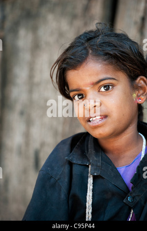 Poor Indian beggar girl staring. Andhra Pradesh, India. Selective focus Stock Photo