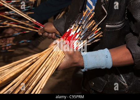 India, Meghalaya, Shillong, Bola archery gambling game, hand holding bunch of colour codedarrows Stock Photo