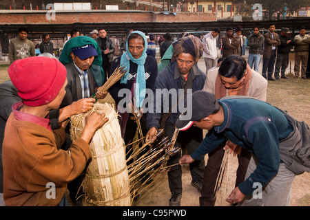 India, Meghalaya, Shillong, Bola archery gambling game, officials counting number of arrows in target Stock Photo