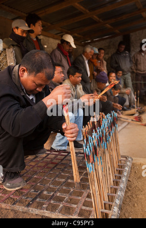 India, Meghalaya, Shillong, Bola archery gambling game, officials sorting and counting number of arrows Stock Photo
