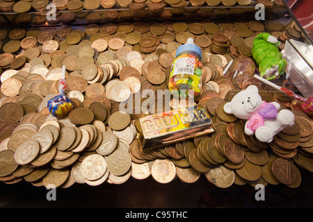 Coins in an arcade gaming machine Stock Photo - Alamy