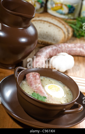 Polish sour rye soup with white sausages Stock Photo