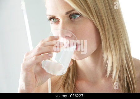 Soluble painkiller. Woman drinking a soluble pain killer. Stock Photo