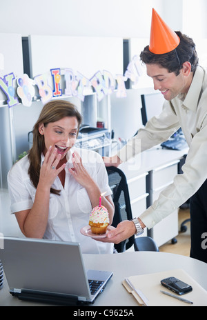 USA, New Jersey, Jersey City, Office workers celebrating birthday Stock Photo