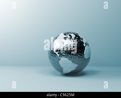 Metallic world globe with visible water ripples Stock Photo