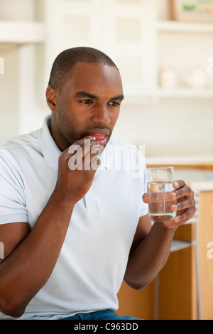 Man taking a pill. Stock Photo
