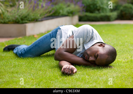 Man in recovery position. Stock Photo