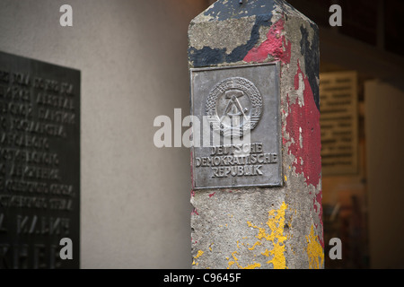 Historical DDR border pole in front of the Wall Museum at Checkpoint Charlie, Berlin, Germany. Stock Photo