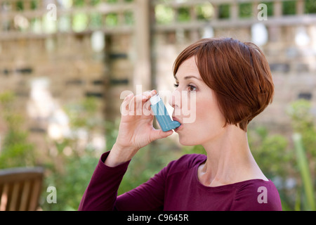 Asthma inhaler use. Stock Photo