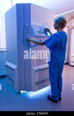 Phototherapy booth. Dermatologist setting up an ultraviolet B phototherapy booth. Stock Photo