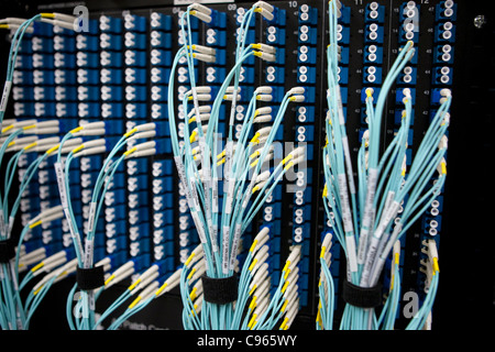 Bundles of network system cables connected to large computer system at a electric power managing facility in Texas Stock Photo