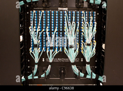 Bundles of network system cables connected to large computer system at a electric power managing facility in Texas Stock Photo