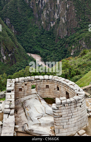 Temple of the sun at ancient Inca ruins of Machu Picchu, the most known tourist site in Andes mountains, Peru. Stock Photo