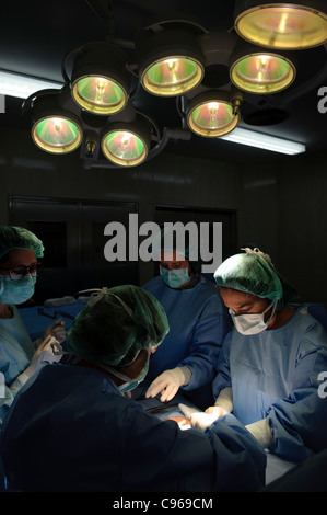 Doctors performing gynecological surgery in operating room Stock Photo ...