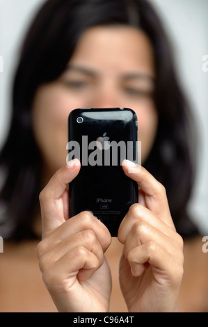 Selective focus photo of woman texting on iPhone Stock Photo