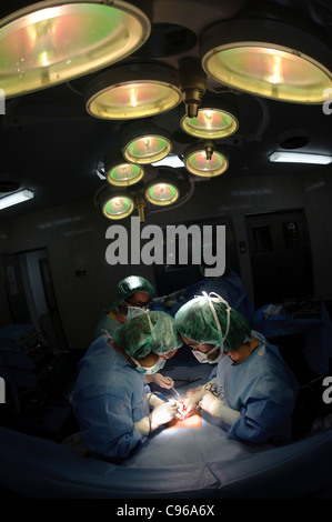 Doctors performing gynecological surgery in operating room Stock Photo ...