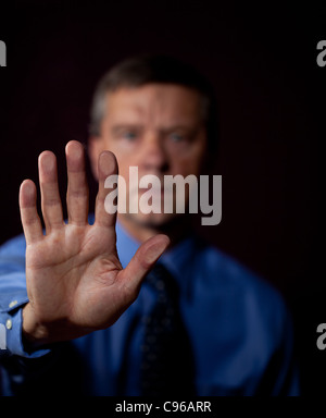 Senior executive or security man opens sensor by pressing hand onto the plate Stock Photo