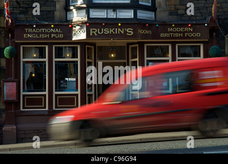 Royal Mail van passing a pub in Bowness, Lake District National Park, Cumbria, England UK Stock Photo