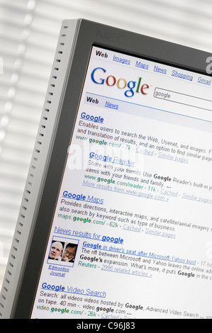 Google search engine page with search results displayed on a computer monitor Stock Photo