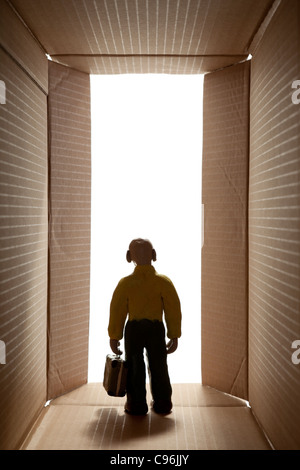 plasticine man with suitcase goes to exit Stock Photo