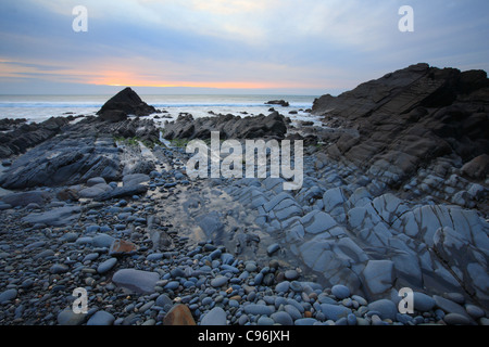 Autumn sunset over rocks at Sandymouth Bay, North Cornwall, England, UK Stock Photo
