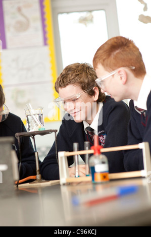 Two Secondary school children boys  doing an experiment in a chemistry  practical lab science class lesson , Wales UK Stock Photo